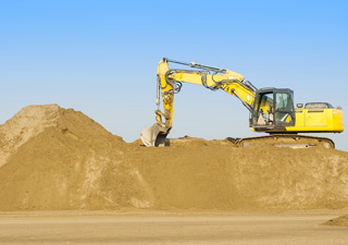 excavator on sand pile
