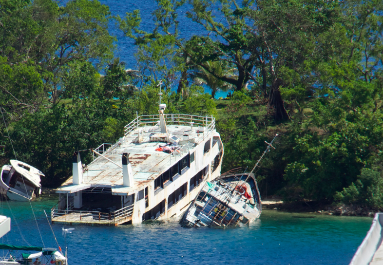 Boats wrecked in shallow waters by Tropical Cyclone Pam